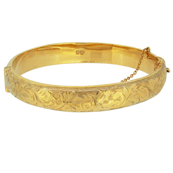 A mid-20th century, silver gilt, hollow, half engraved hinged bangle.