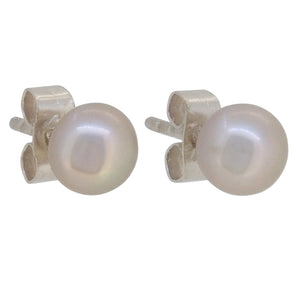A pair of modern, silver, pearl set stud earrings.