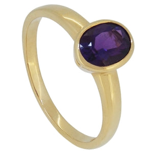 A modern, 18ct yellow gold, amethyst set single stone ring.