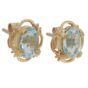 A pair of modern, 9ct yellow gold, blue topaz set stud earrings.