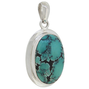 A mid-20th century, silver, turquoise matrix set pendant.