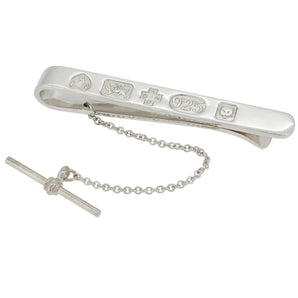 A modern, silver tie slide with feature spread hallmarks.