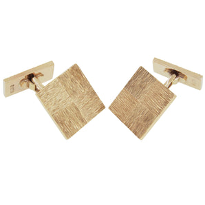A pair of mid-20th century, 9ct yellow gold, square, bar & toggle link cufflinks with bark effect decoration.