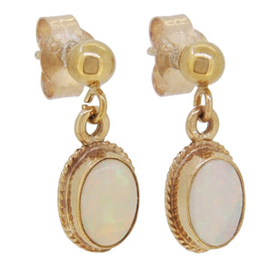 A pair of mid-20th century, 9ct yellow gold, opal set drop earrings with cord borders.