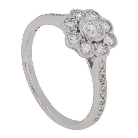 A modern, 18ct white gold, diamond set, nine stone daisy cluster ring
