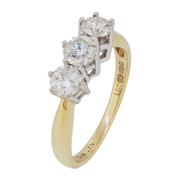 A modern, 18ct yellow & white gold, diamond set three stone ring.