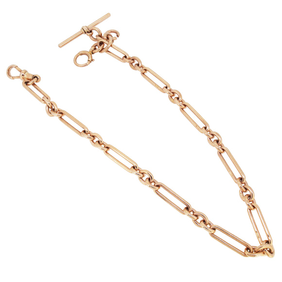 An Edwardian, 9ct rose gold, trombone link Albert chain.