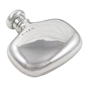 A silver spirit flask with a screw on lid