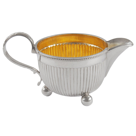 A Victorian, silver cream jug with a gilt interior