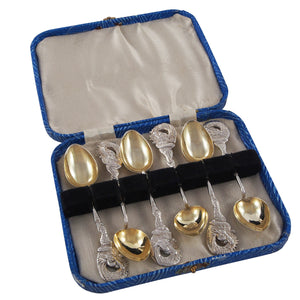 Six mid-20th century, silver, spoons with a dragon at each terminal end & fitted case