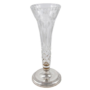 A modern, glass vase on a silver base