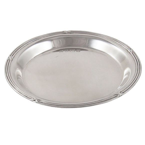 A modern, silver, circular pin tray