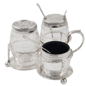 A Victorian, silver & cut glass, three piece bottle cruet on a stand with ball feet, twisted wire borders & a loop handle.