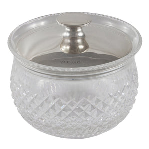An early 20th century, circular cut glass jar with a silver lid.