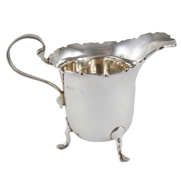 An early 20th century, silver cream jug on three feet