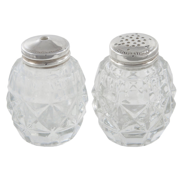 A pair of cut glass salt & pepper pots with silver lids
