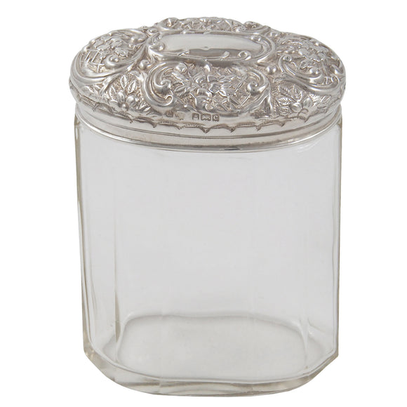 An Edwardian, glass jar with an embossed silver lid