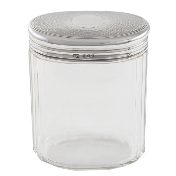 An Edwardian, glass jar with a silver, engine turned lid