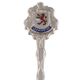 >A mid-20th century, silver, enamel set souvenir teaspoon featuring a crest of Leominster.