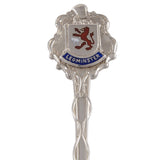 A mid-20th century, silver, enamel set souvenir teaspoon featuring a crest of Leominster.