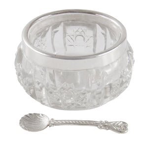 An early 20th century, cut glass open salt with a silver rim & silver spoon.