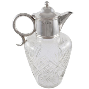 An Edwardian, glass, silver topped claret jug