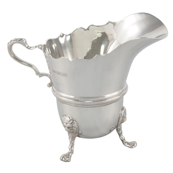 A modern, silver, James Pattern cream jug on three claw feet