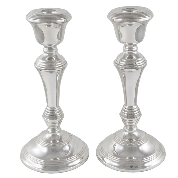 A pair of modern, silver candlesticks