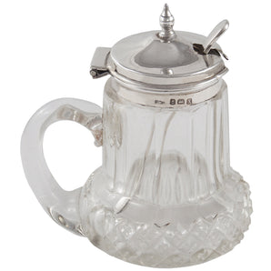 An early 20th century, glass mustard pot with a silver mounted lid & spoon.