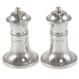 A pair of early 20th century, silver pepper pots