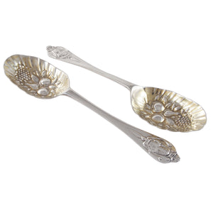 A pair of Victorian, silver berry spoons with worn gilt bowls