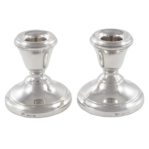 A pair of modern, silver candlesticks