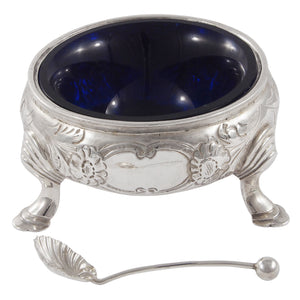 A Victorian, silver, circular open salt with a blue glass liner & spoon