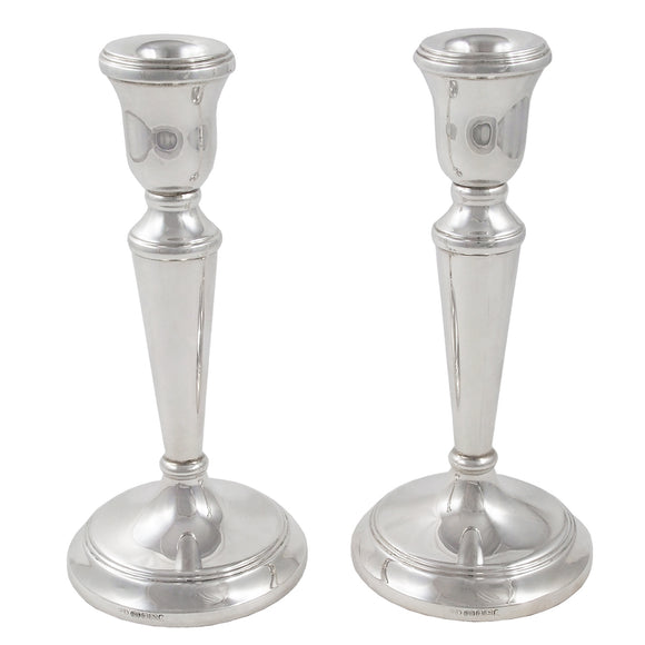A pair of modern, silver candlesticks