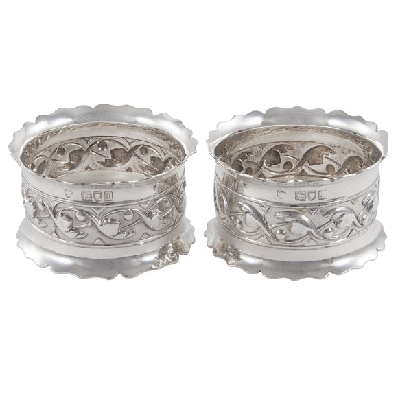 A pair of Edwardian, silver, embossed napkin rings