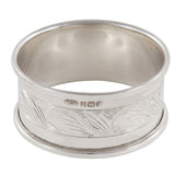 A modern, silver napkin ring engraved with the name Christopher