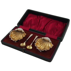 A pair of Victorian, silver & silver gilt, open shell salts & spoons & fitted case
