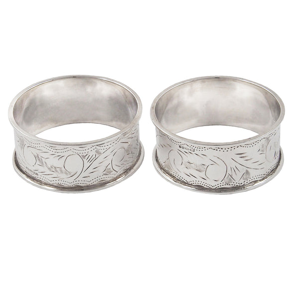 A pair of modern, silver, engraved napkin rings
