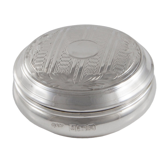 A modern, silver, engine turned, lidded circular pill box