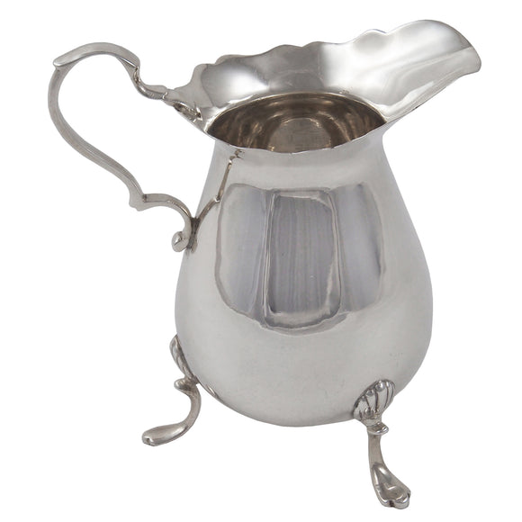 An Edwardian, silver cream jug on three feet