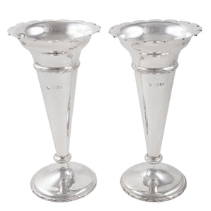 A pair of Edwardian, silver trumpet vases with scalloped rims.