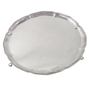 An early 20th century, silver salver with a bead edge on three feet