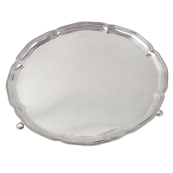 An early 20th century, silver salver with a bead edge on three feet