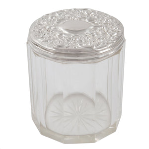 An Edwardian glass jar with a silver lid