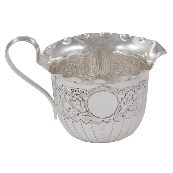 A Victorian, silver, embossed cream jug