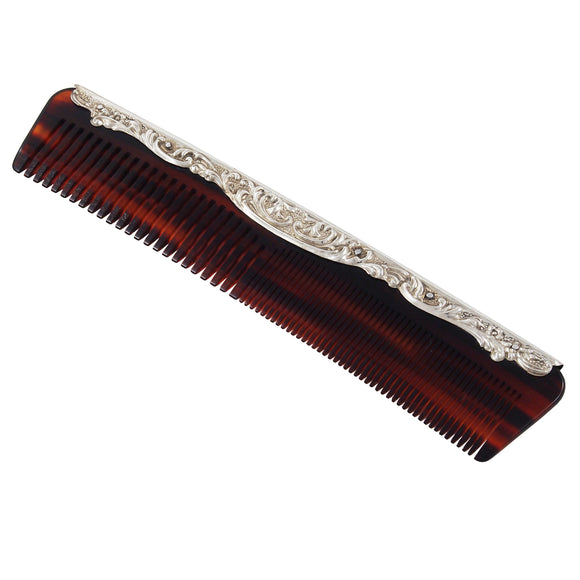 A modern hair comb with a silver mount