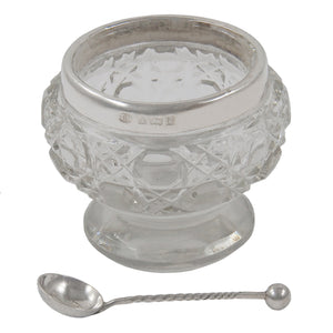 An Edwardian, glass open salt with a silver rim & spoon