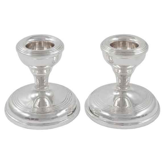 A pair of mid-20th century, silver, squat candlesticks