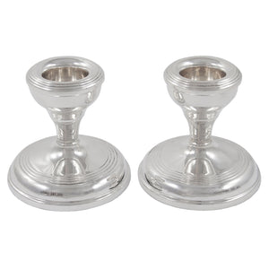 A pair of mid-20th century, silver, squat candlesticks.