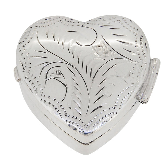 A modern, silver, engraved, heart shaped pill box